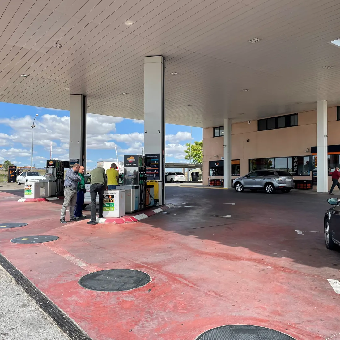 Cars at the pumps on the new red floor Cars at the pumps on the new red floor