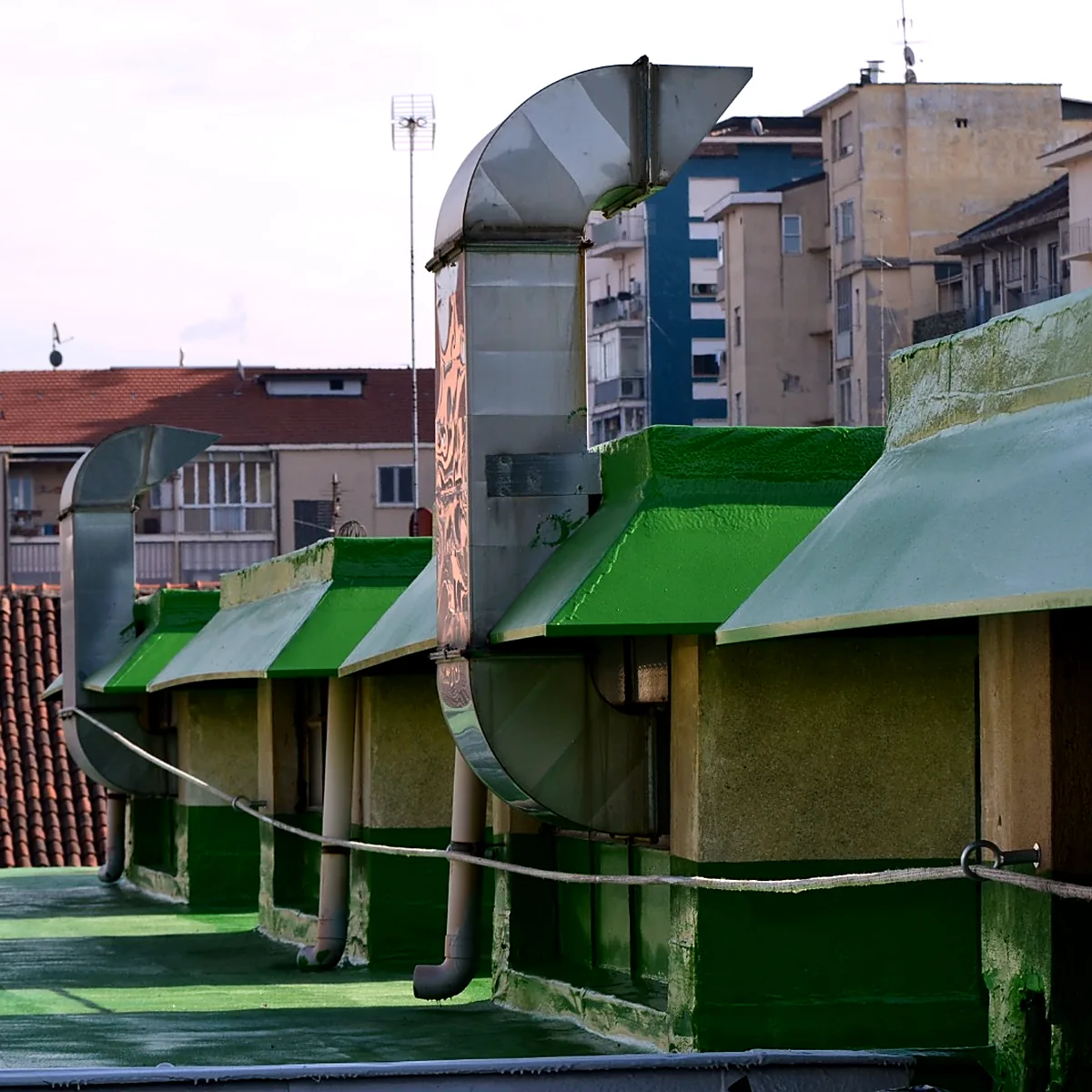 Green-coated roof vents and duct on the mall roof in Turin, Italy Green-coated roof vents and duct on the mall roof in Turin, Italy