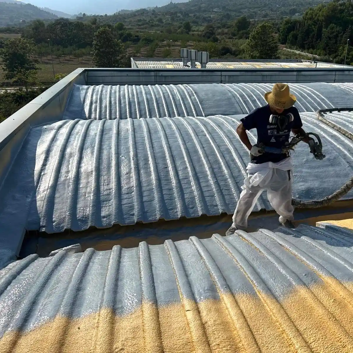 Applicator spraying while standing on the ribbed roof, Tarragona