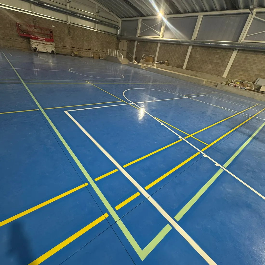 White and yellow lines crossing on the blue floor White and yellow lines crossing on the blue floor