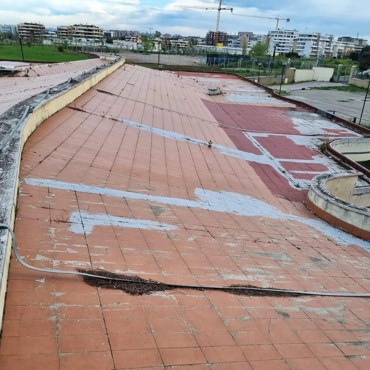 Cracked terracotta tile roof at the Calimero nursery before works, Rome