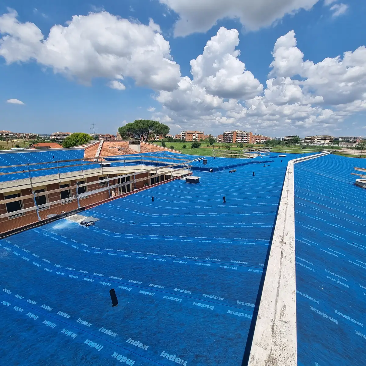 Blue bituminous sheet following the curved nursery roof deck