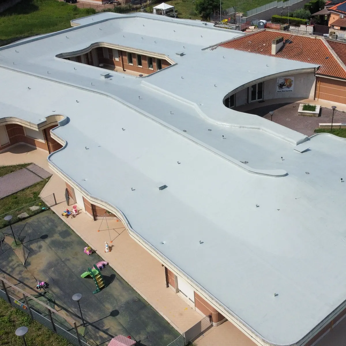 Finished light-grey nursery school roof seen from above, Rome