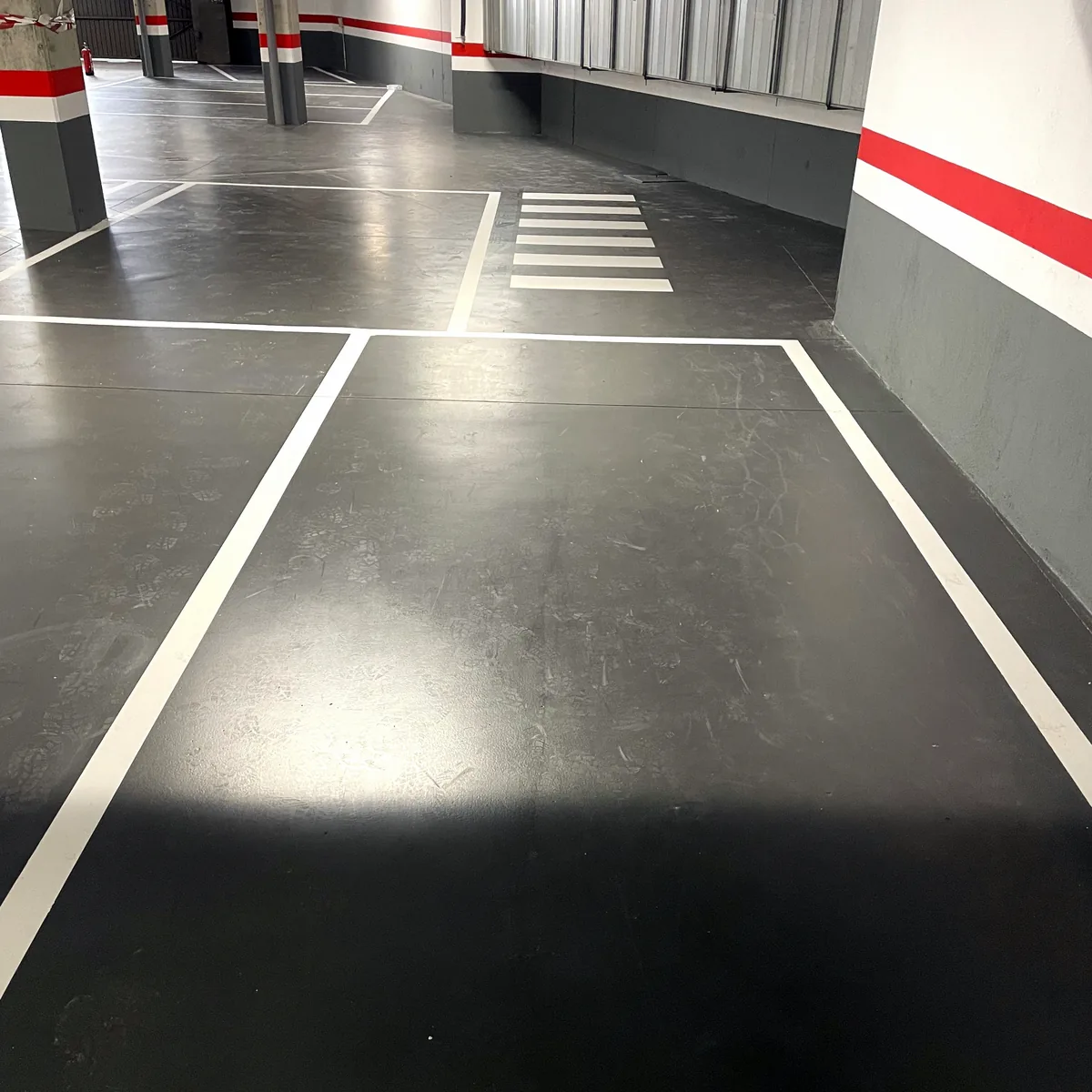 White crossing bars painted near the wall and the ramp White crossing bars painted near the wall and the ramp