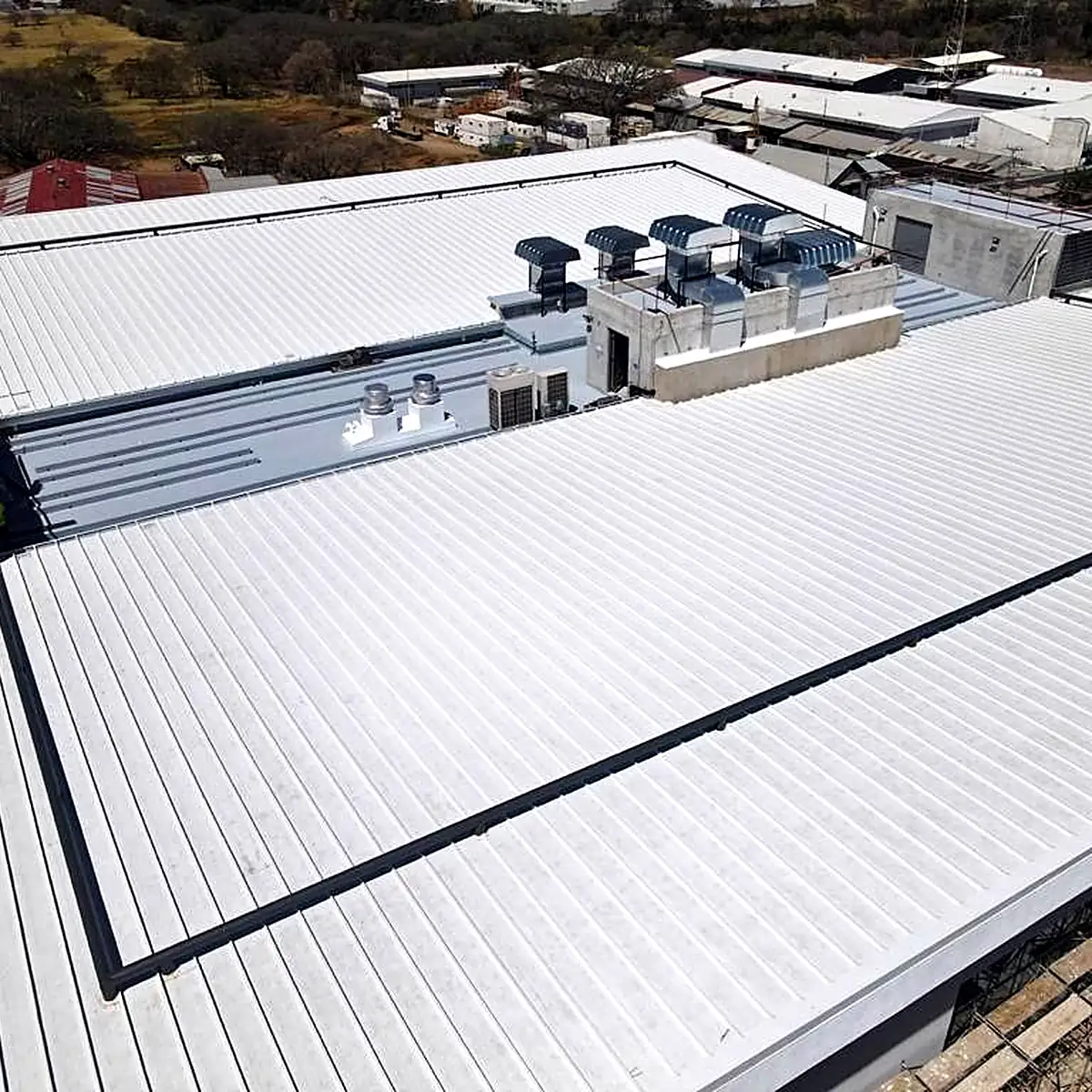 Aerial view of the light grey office roof and its equipment, Costa Rica