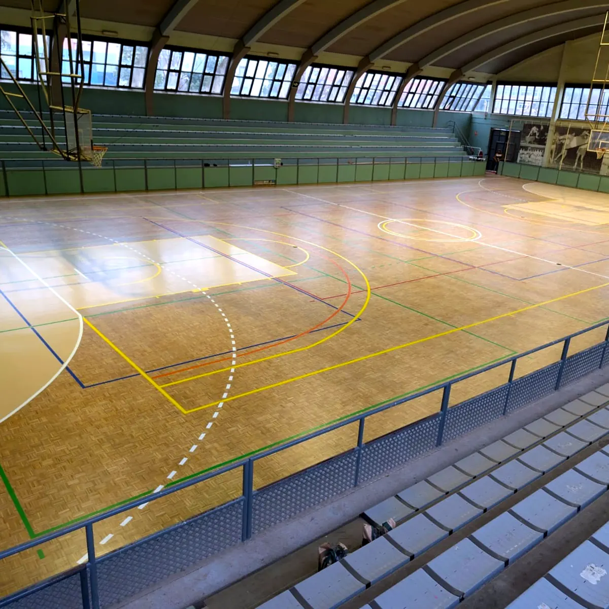 Finished parquet court with coloured lines seen from the stands, Granollers