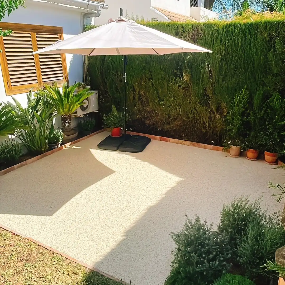 Pale aggregate paving under a garden umbrella Pale aggregate paving under a garden umbrella