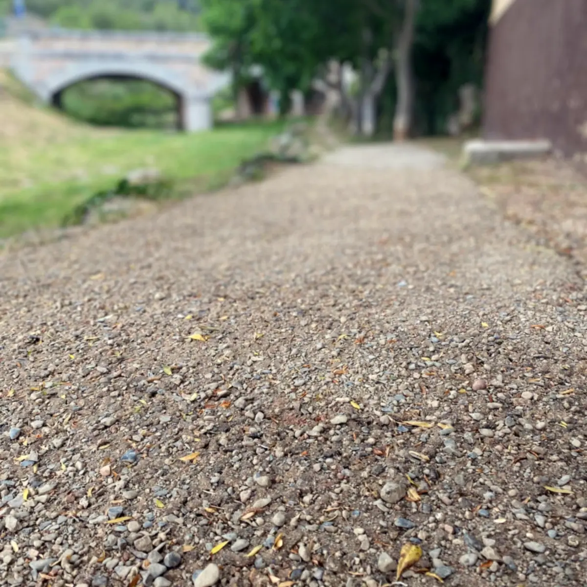 Close view of resin-bound stone on the path, with the bridge behind Close view of resin-bound stone on the path, with the bridge behind