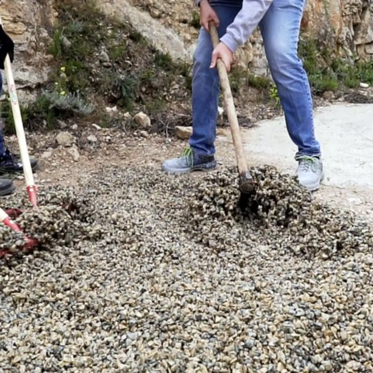 Crew raking the Pavistone 2K and stone mix along the path Crew raking the Pavistone 2K and stone mix along the path