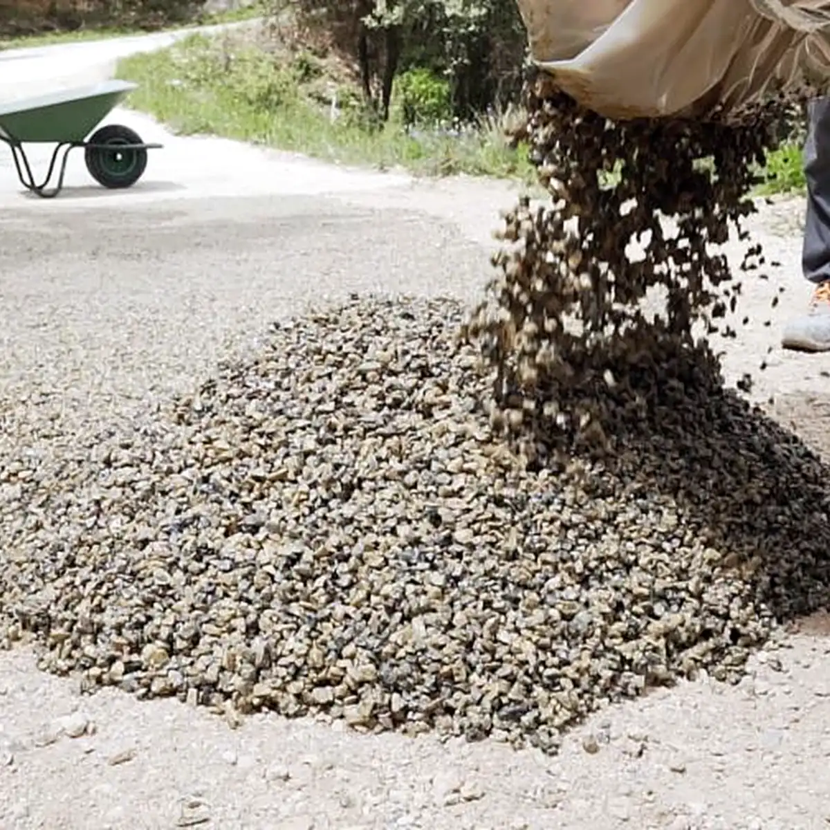 Bound stone mix tipped from a tracked dumper onto the path base Bound stone mix tipped from a tracked dumper onto the path base