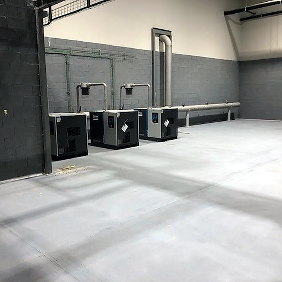 Long view of the machinery room with units along the wall Long view of the machinery room with units along the wall