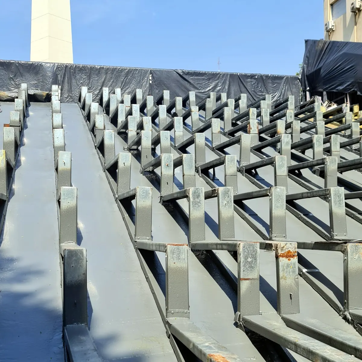 Grey sprayed membrane between the steel frames of the police centre roof