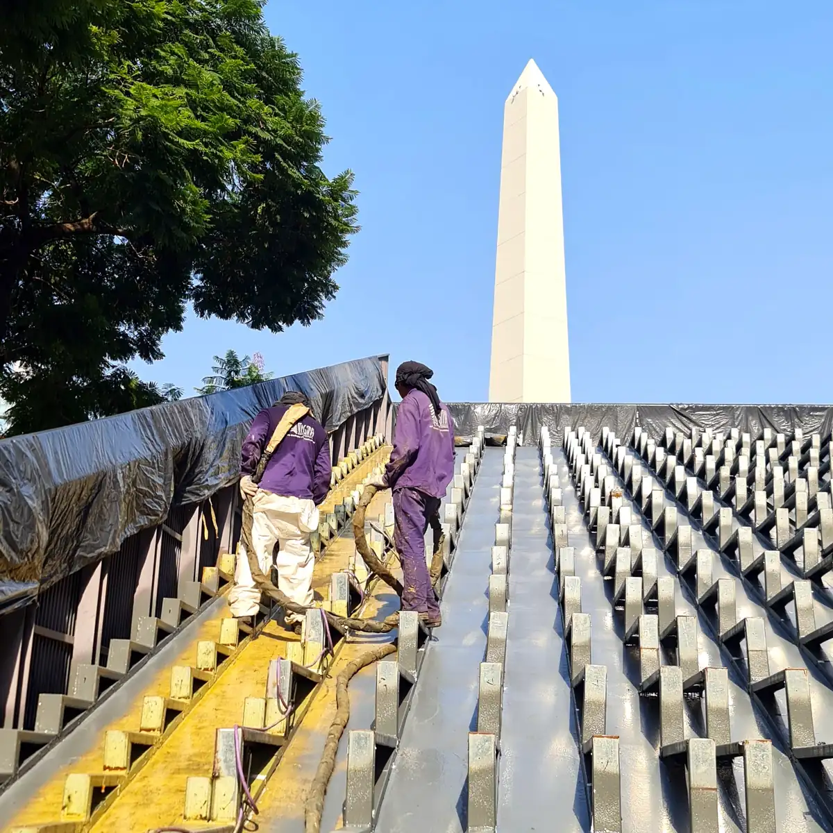 Freshly sprayed strips on the sloped roof with the Obelisco behind, Buenos Aires
