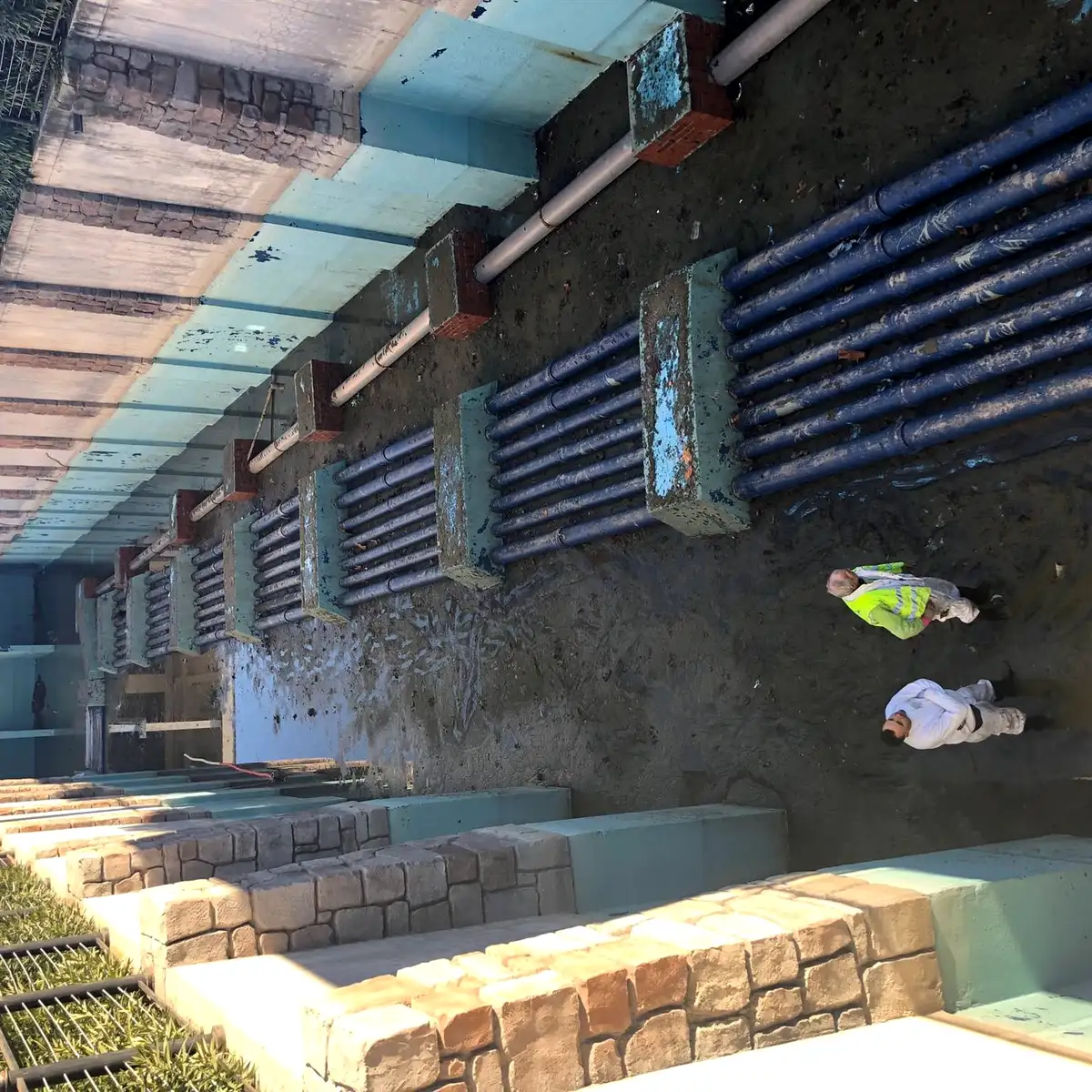 Overhead view of a channel with pipe manifolds and crew, Parque Warner Madrid