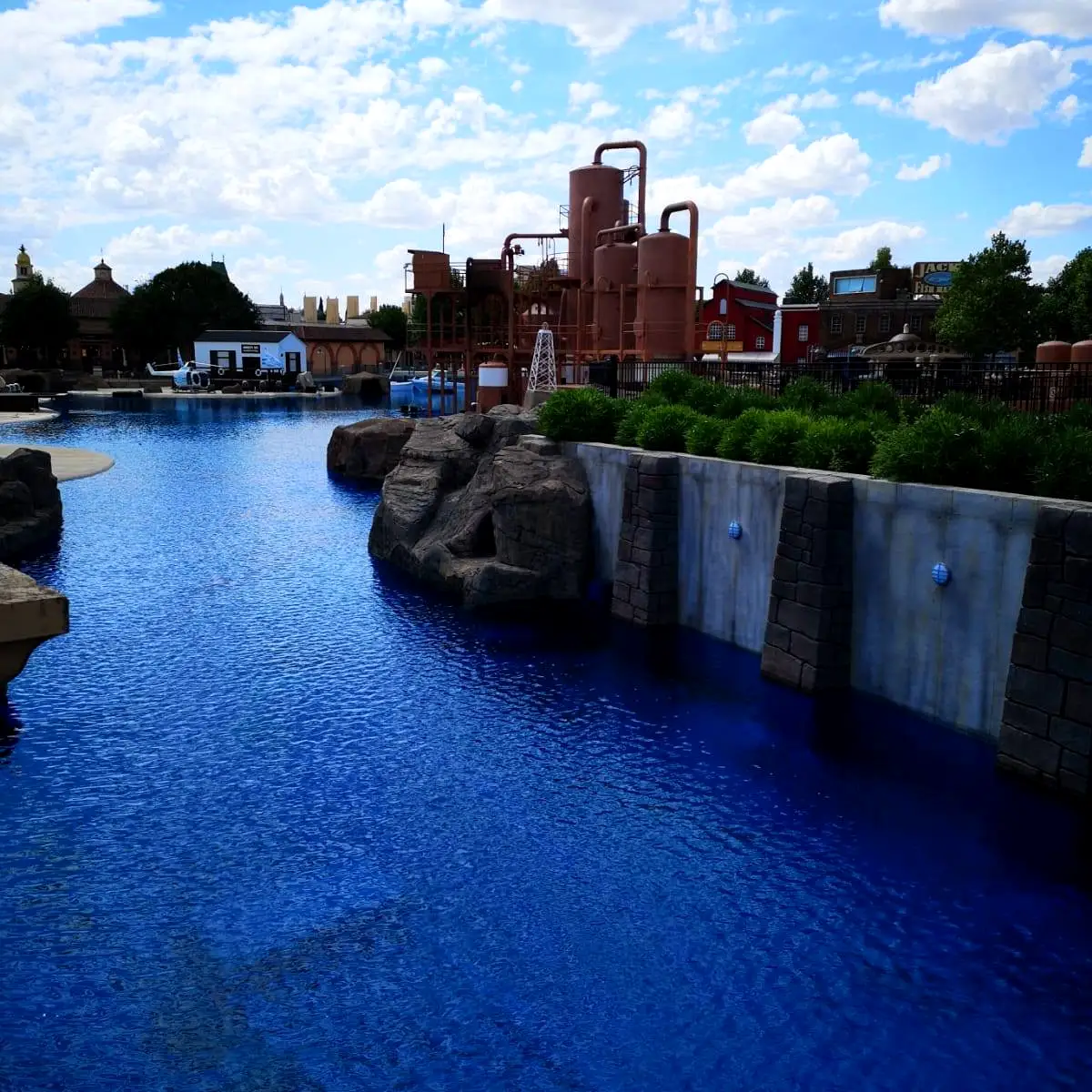 Filled lake with rockwork edge and themed tower, Parque Warner Madrid