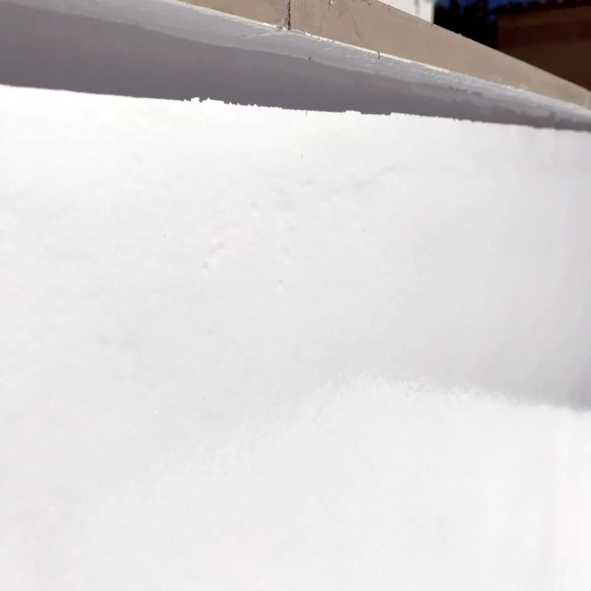 Close view of the smooth white coat on a pool wall Close view of the smooth white coat on a pool wall