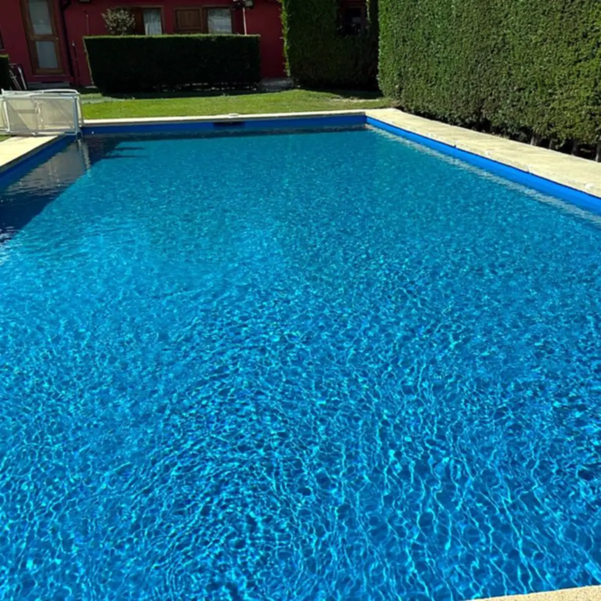 Full pool with a steel ladder at the far end Full pool with a steel ladder at the far end