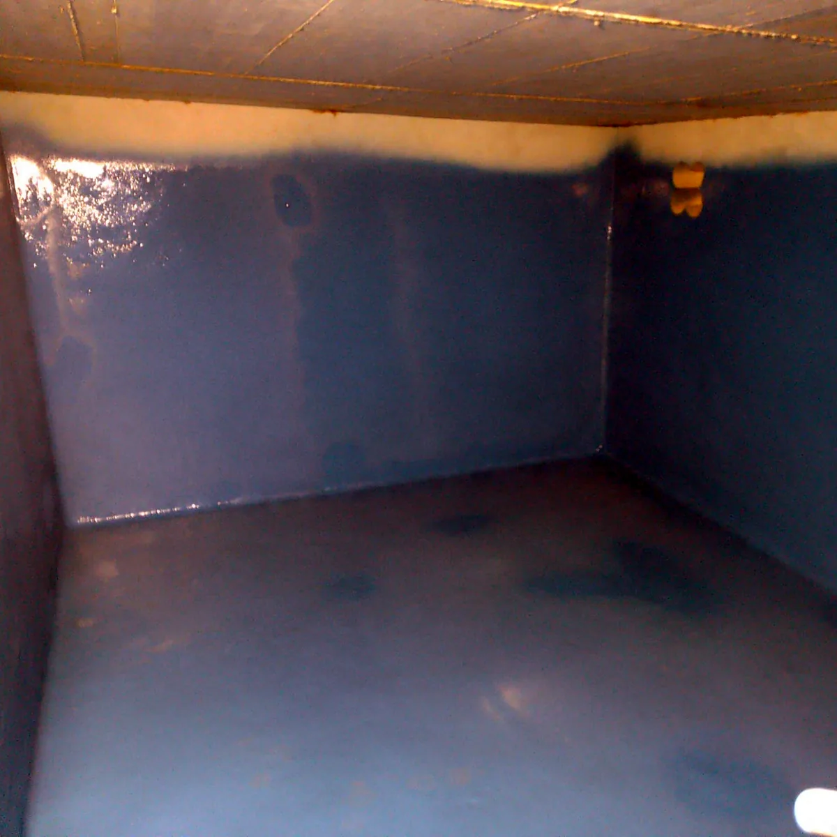 Bright blue tank interior with the floor and walls fully lined