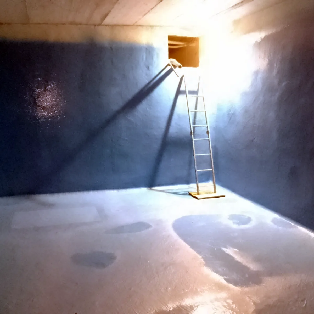 Access ladder below the hatch inside the blue-lined water tank