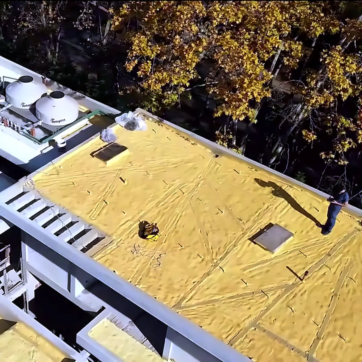 Aerial view of yellow polyurethane foam insulation on the flat roofs of a house in San Isidro, Argentina Aerial view of yellow polyurethane foam insulation on the flat roofs of a house in San Isidro, Argentina