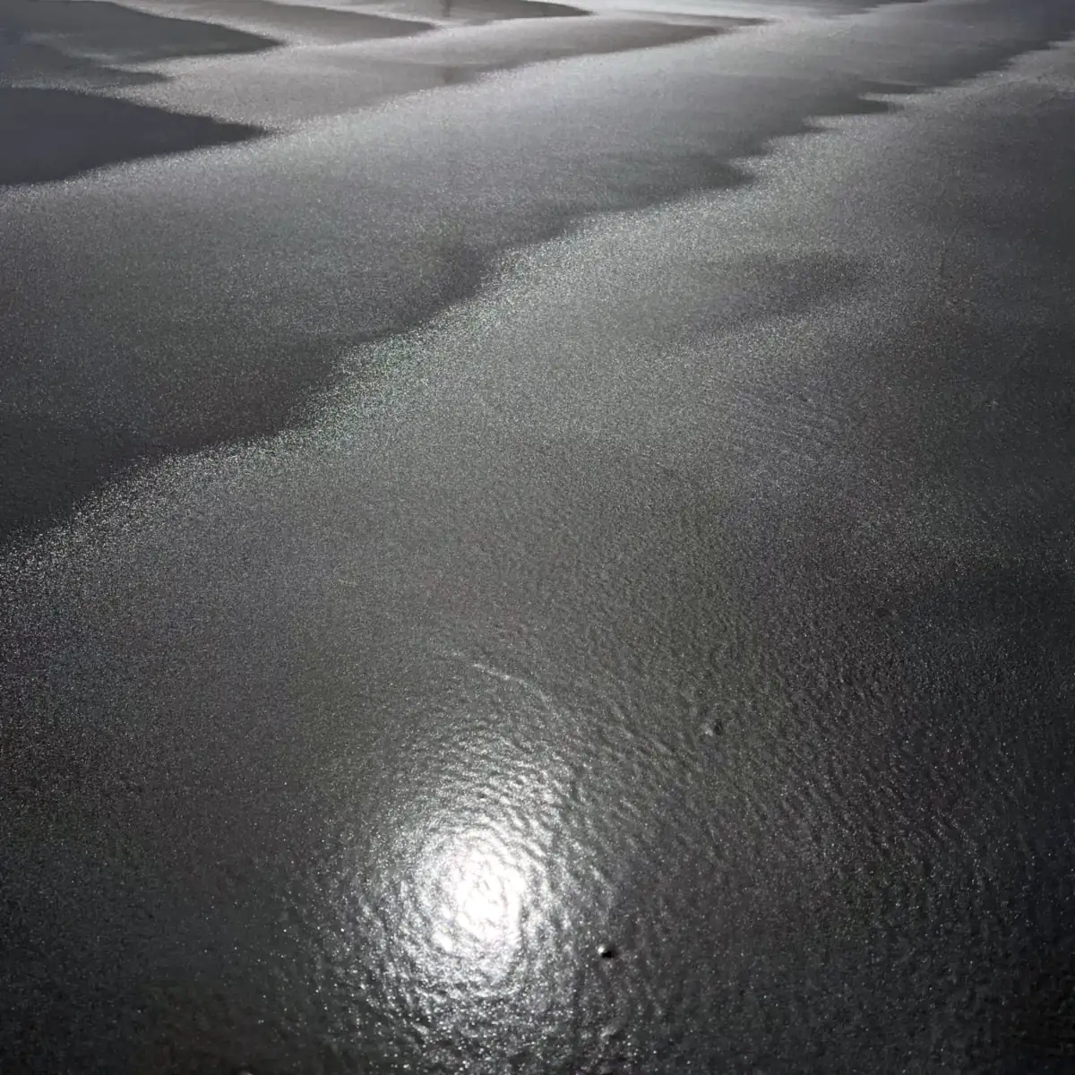 Sunlight reflecting on the fresh grey surface beside a joint line