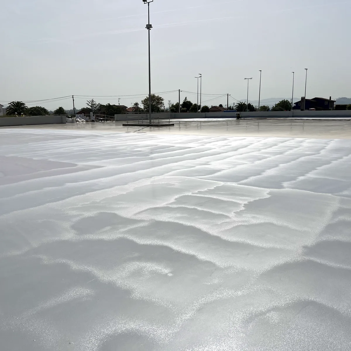 Rows of light posts at the far edge of the coated roof