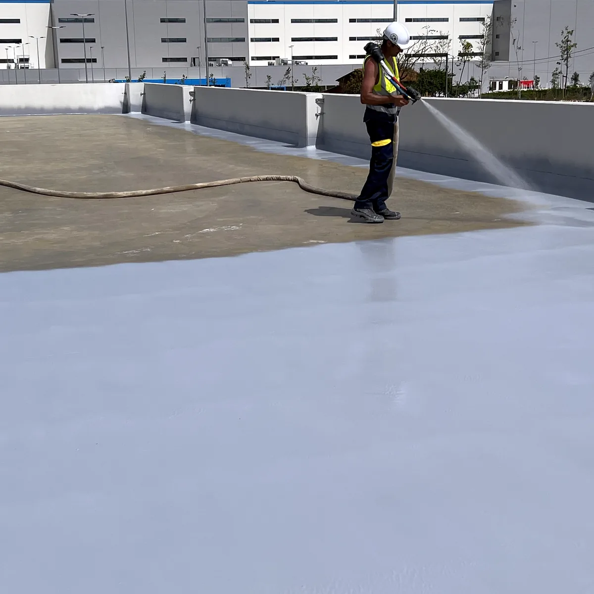 Applicator with a spray gun working across the deck, La Línea
