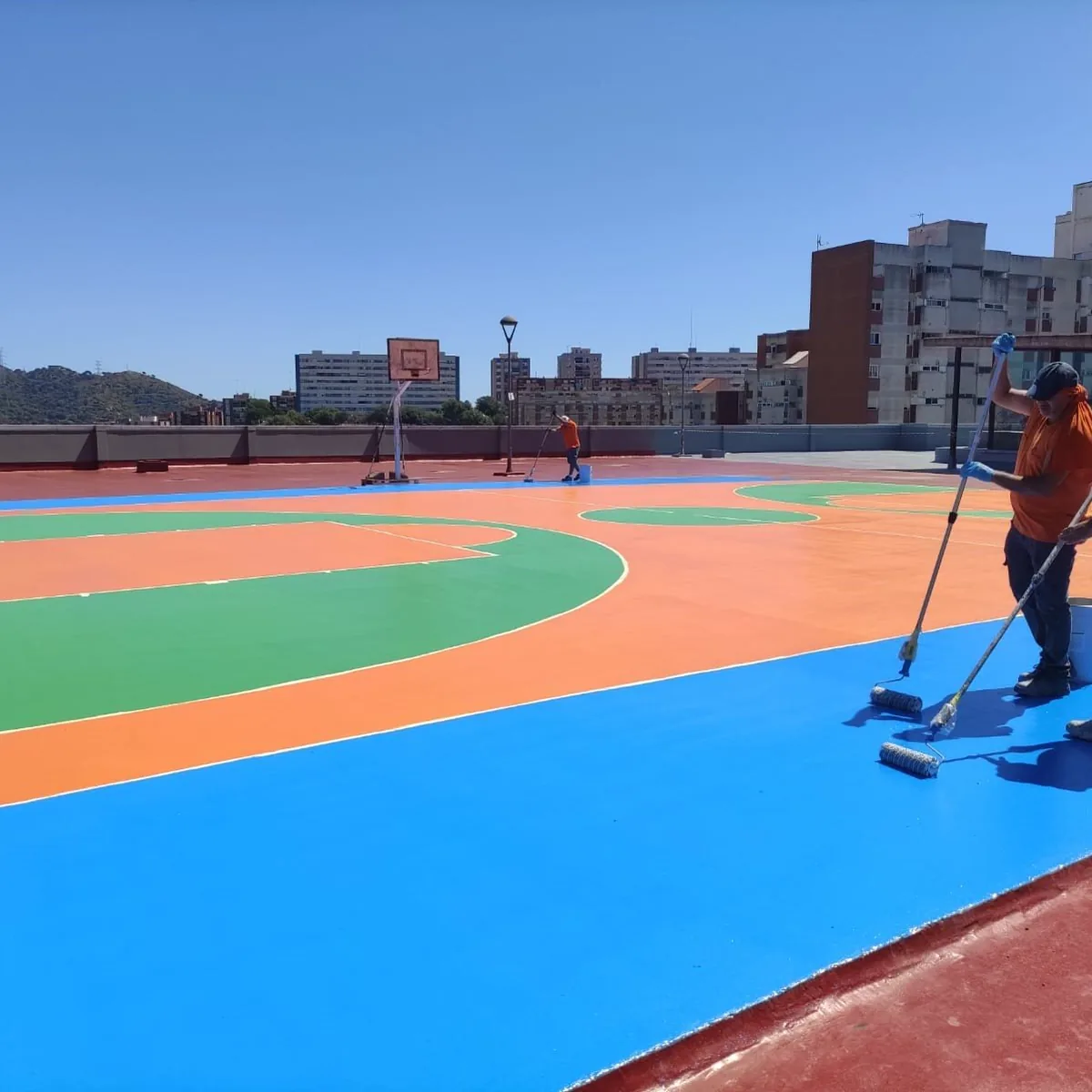 Crew finishing the light-blue border of the court, Montcada i Reixac