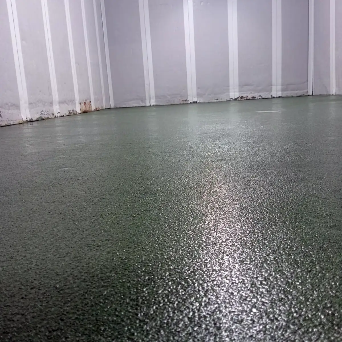 Green floor with a fine aggregate texture under the room lights Green floor with a fine aggregate texture under the room lights