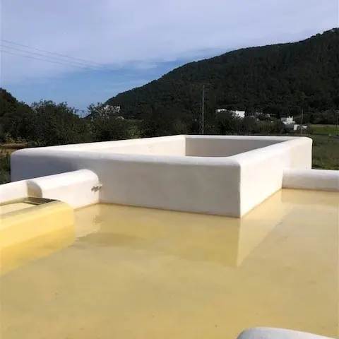 Yellow membrane around a white roof parapet