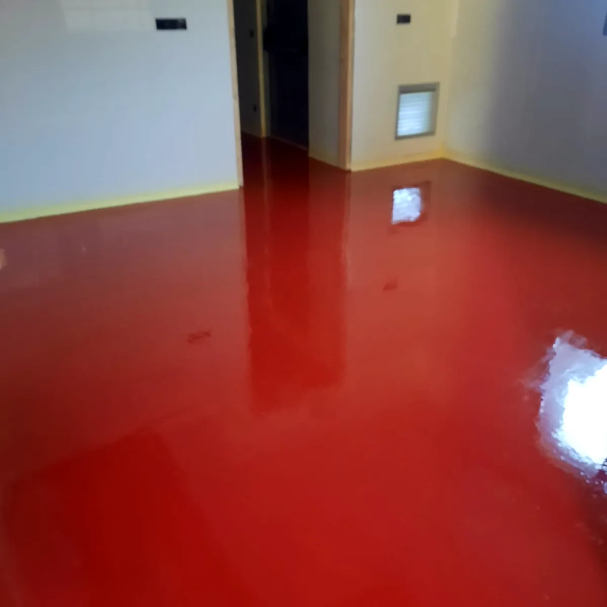 Glossy red floor in a white room with a doorway, Sant Pere de Casserres Glossy red floor in a white room with a doorway, Sant Pere de Casserres