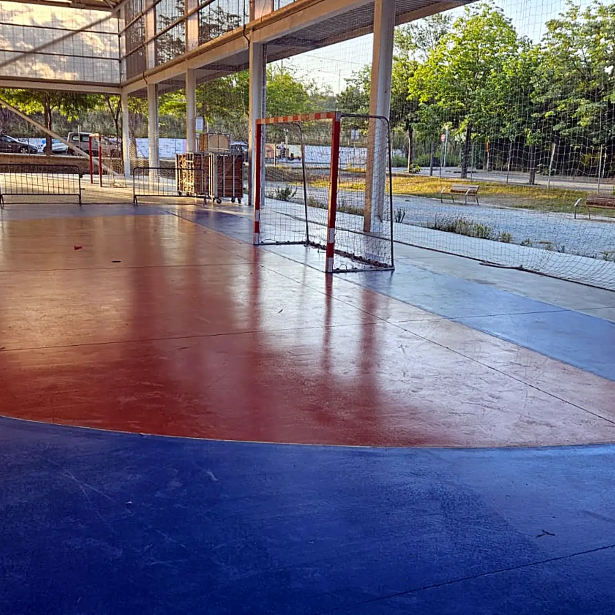 Sports pavilion flooring in Granollers seen toward the goal and the trees