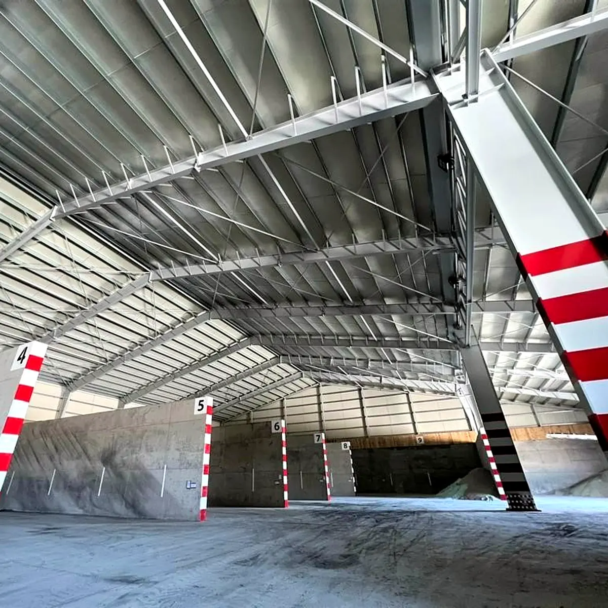 Coated galvanised columns and roof beams along the farm building in Almazán