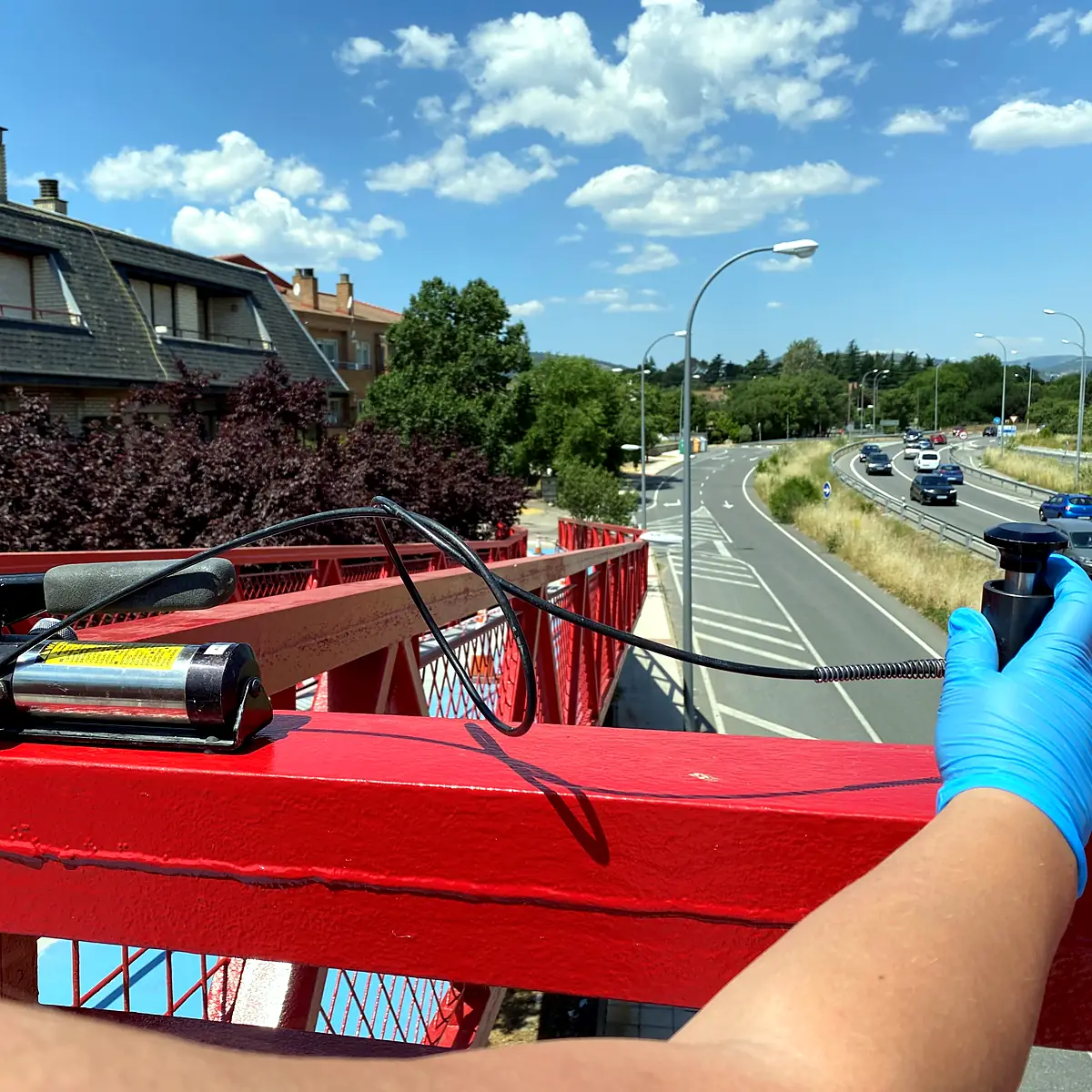 Gauge check on the red coating of a walkway handrail, Madrid