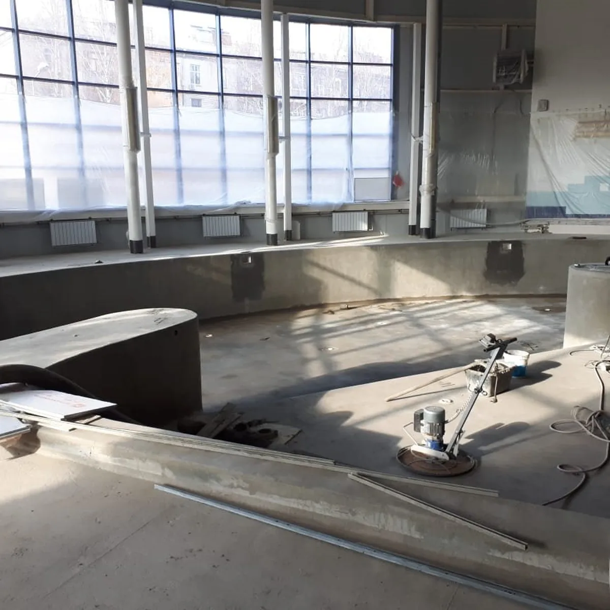 Pool basin under tall windows during preparation, Russia