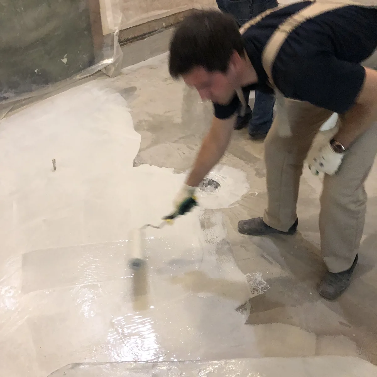 Applicator brushing a pool edge detail, Nizhny Novgorod