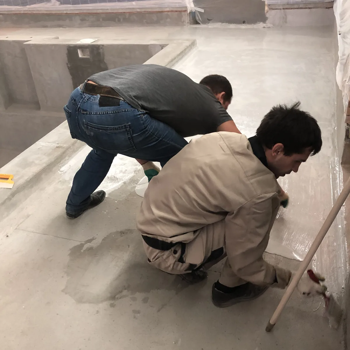 Workers detailing a junction on the pool floor, Russia