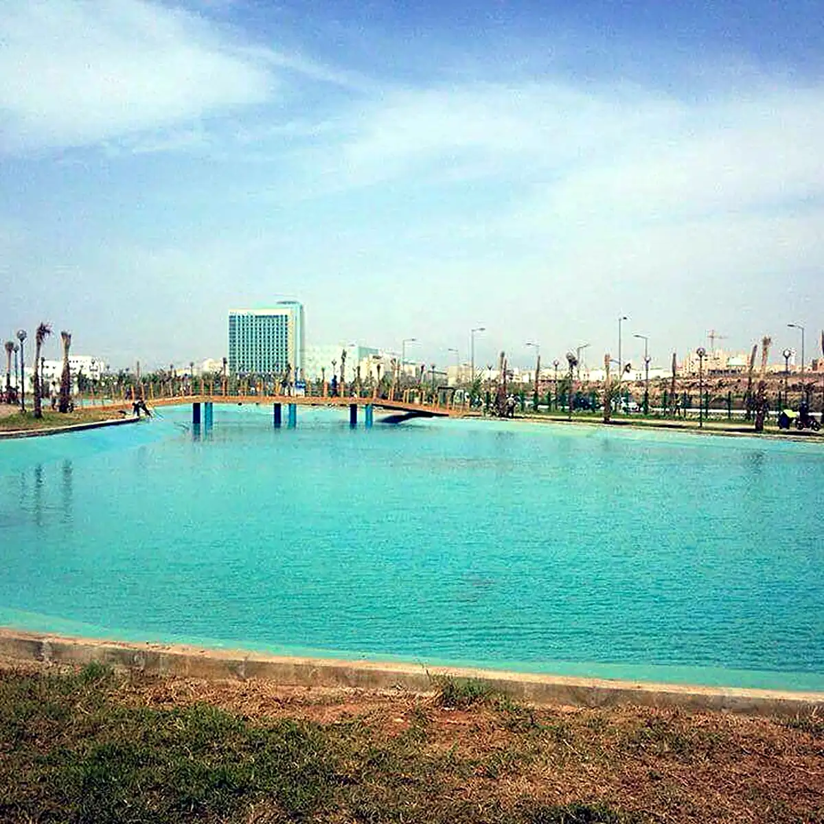 Turquoise water in the newly filled lake beside the promenade