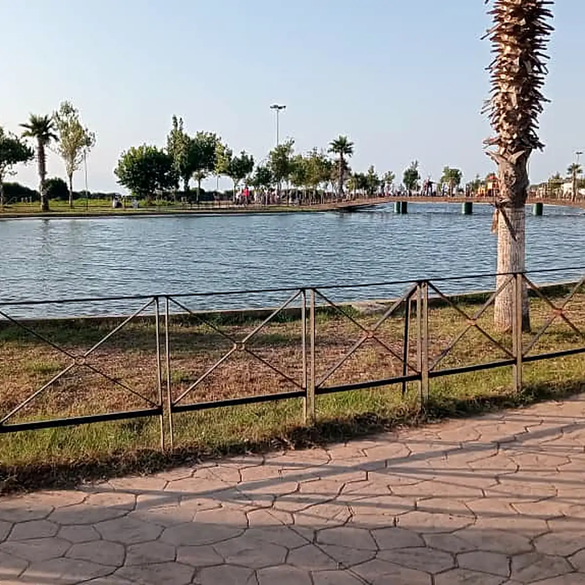 Curving promenade along the filled urban lake in 2026