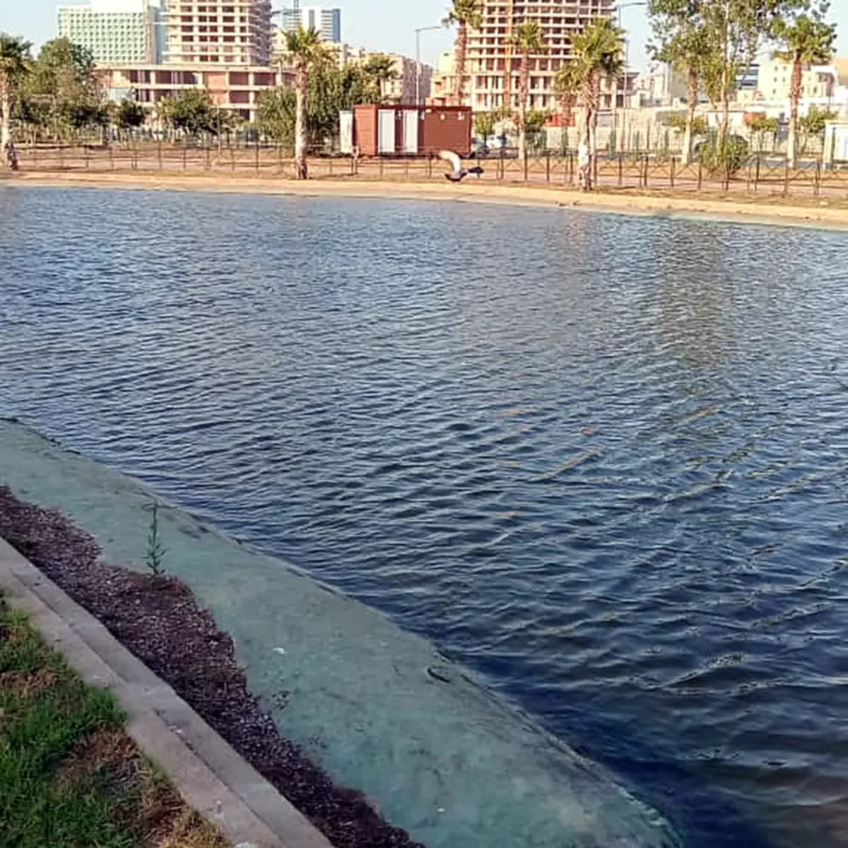 Water meeting the sloped edge with towers behind, 2026
