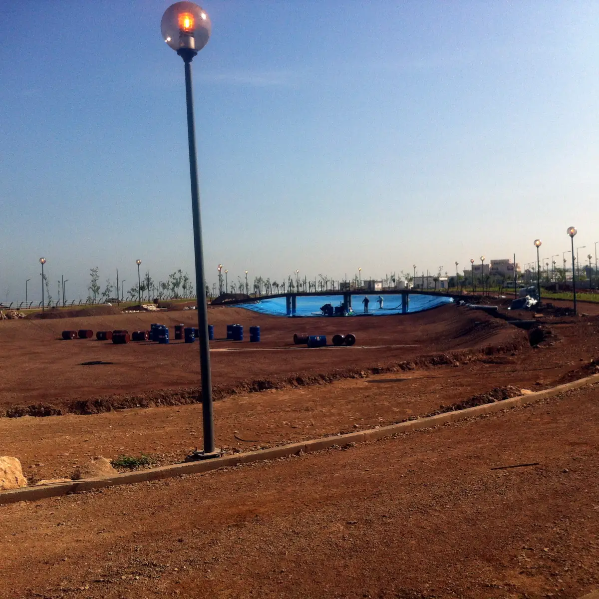 Distant view of the lined basin across the park grounds
