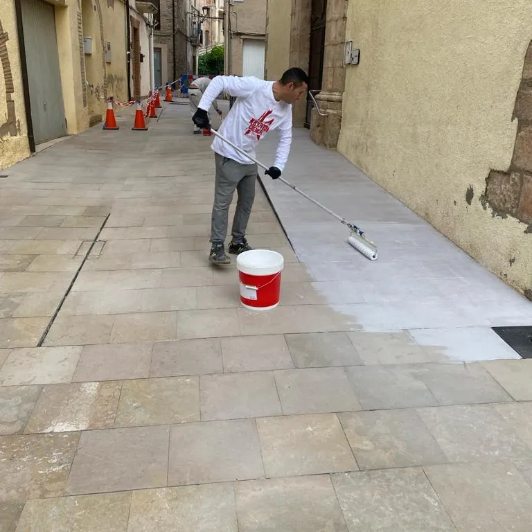 Sellado transparente sobre el vial de piedra entre las viviendas