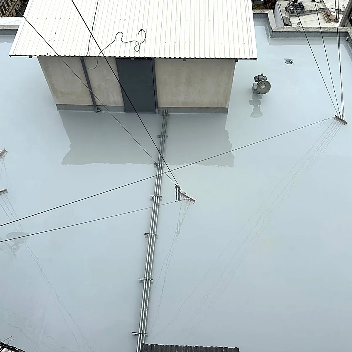 Coated roof around a small rooftop building Coated roof around a small rooftop building