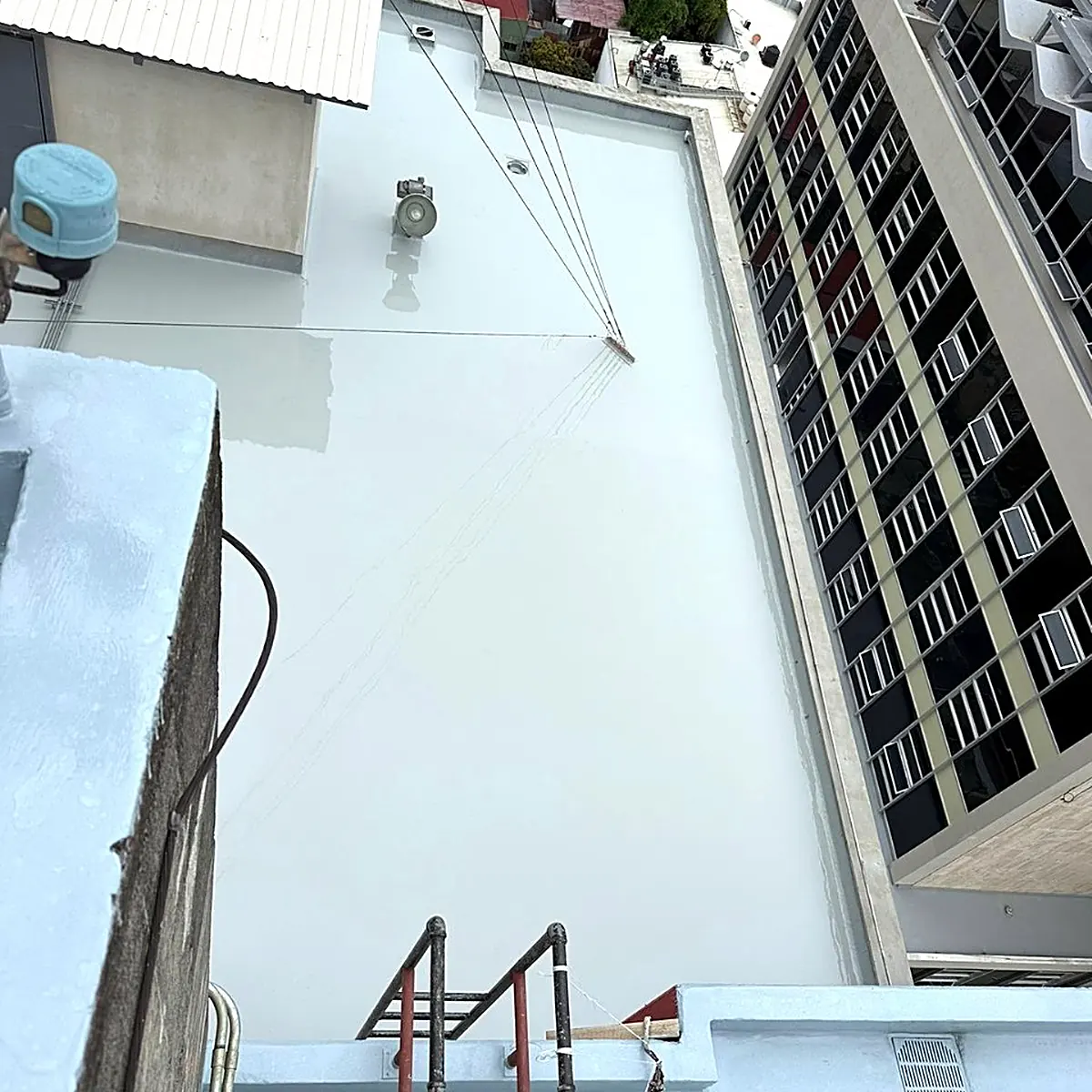 Coated roof edge high above the street Coated roof edge high above the street