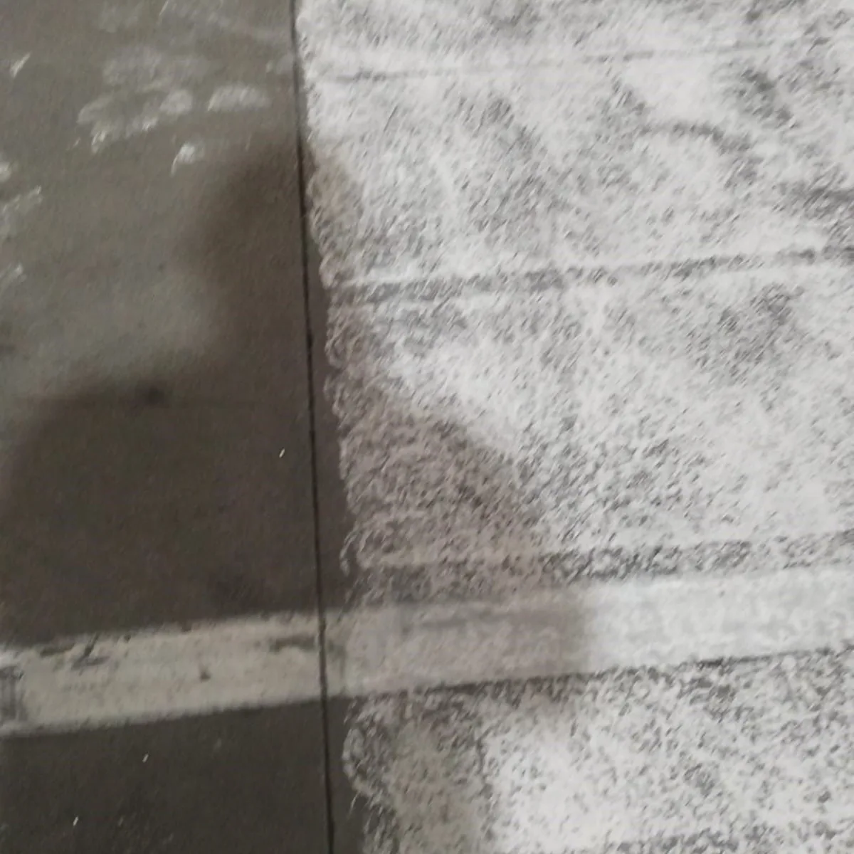 Anti-slip texture of the grey epoxy floor, close view, Constantí
