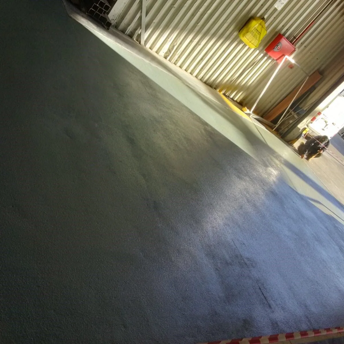 Primer coat on the warehouse slab in low sun, Constantí