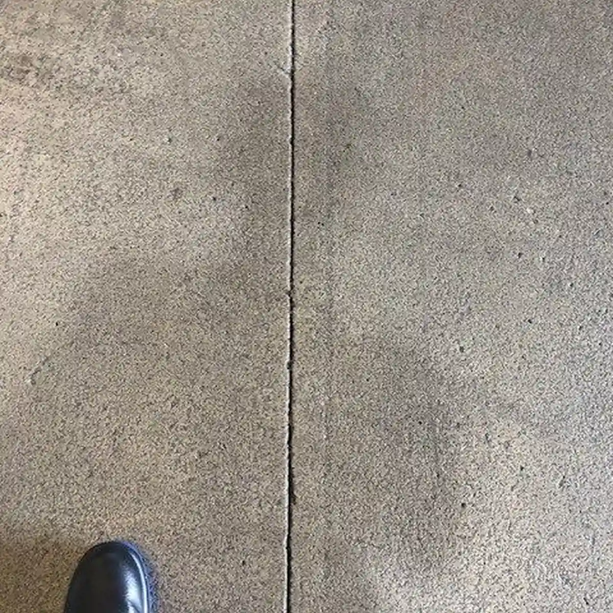 Worn concrete slab and saw joint before coating, Constantí