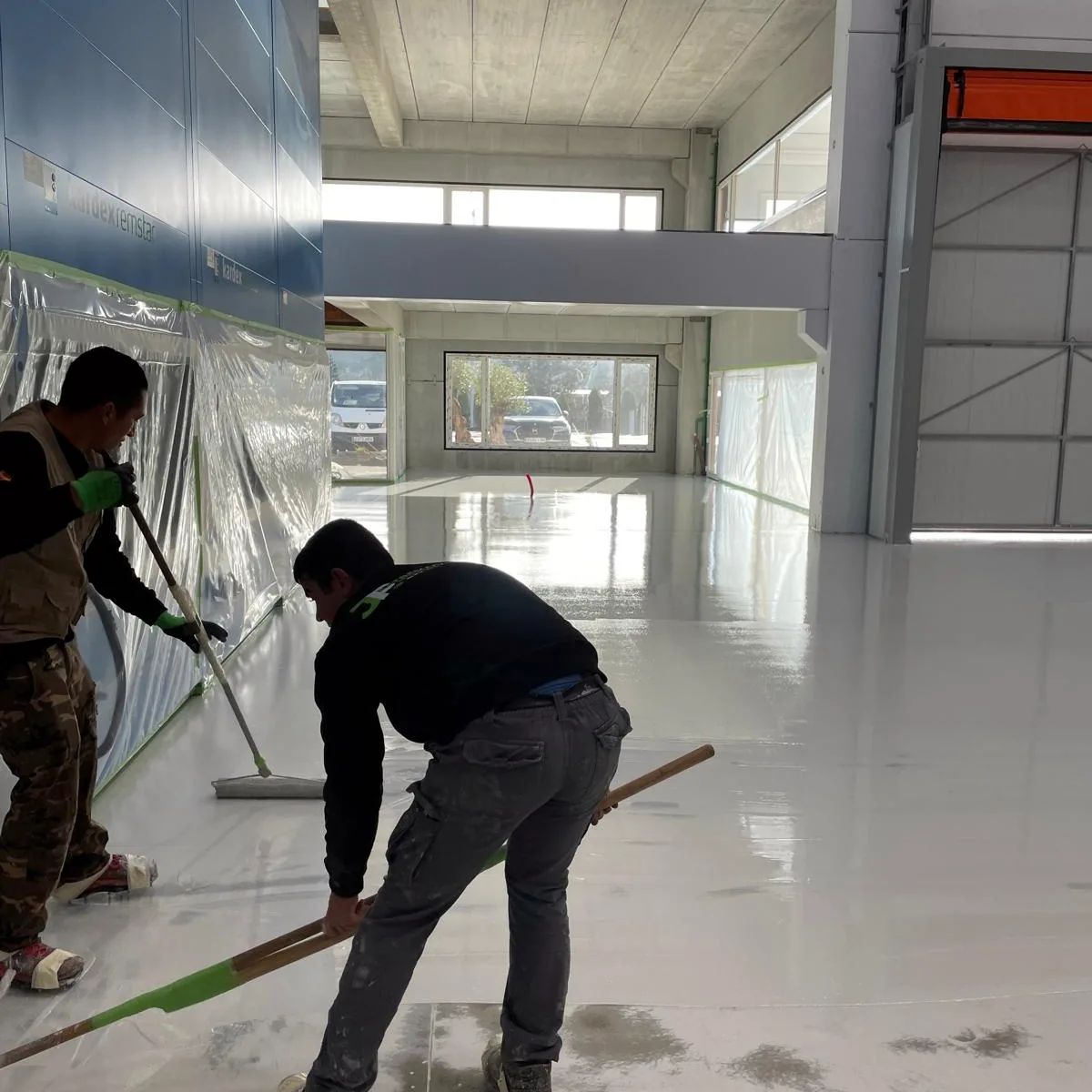 Squeegee work along the edge of the hall