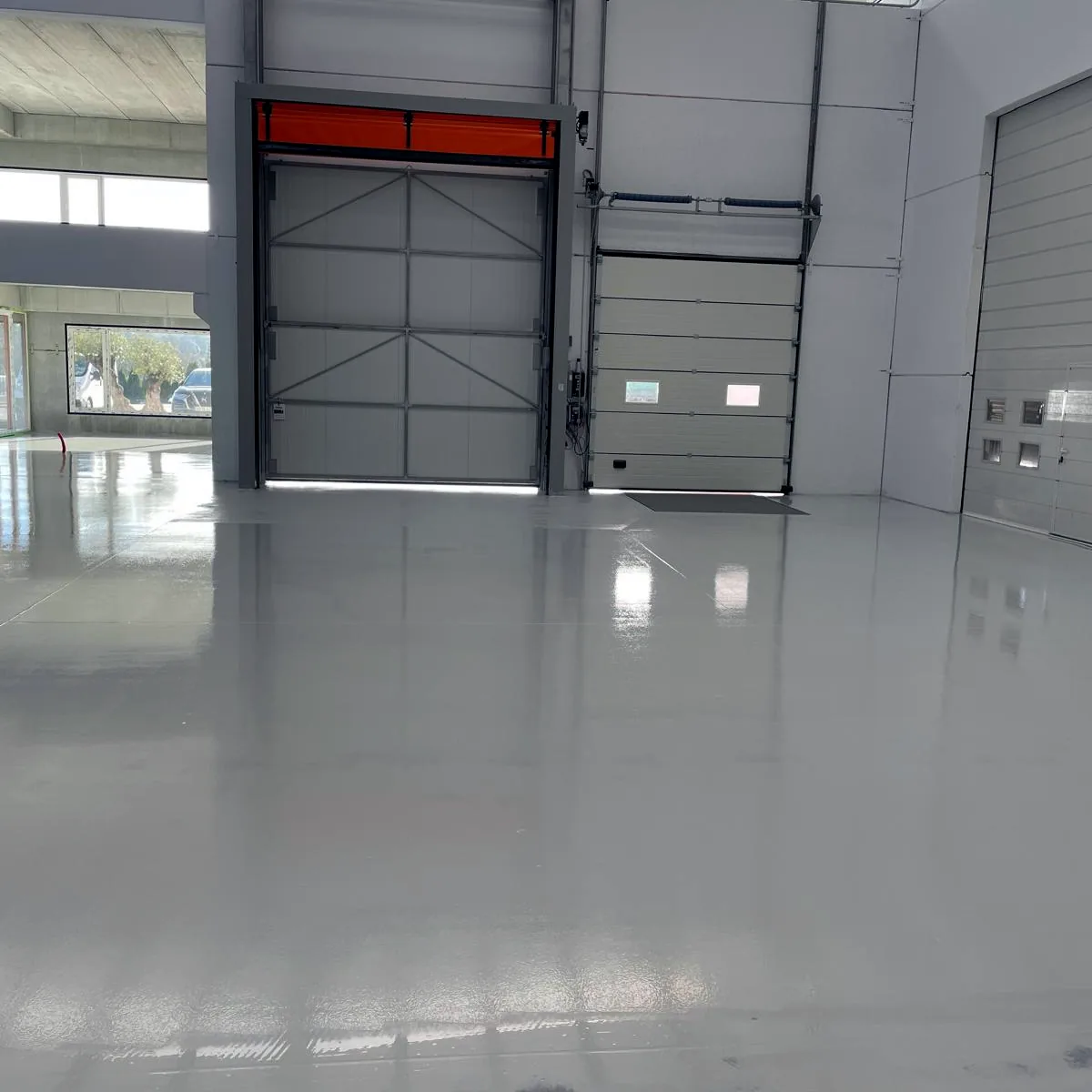 Finished hall with sectional doors and a glossy light floor, Galicia
