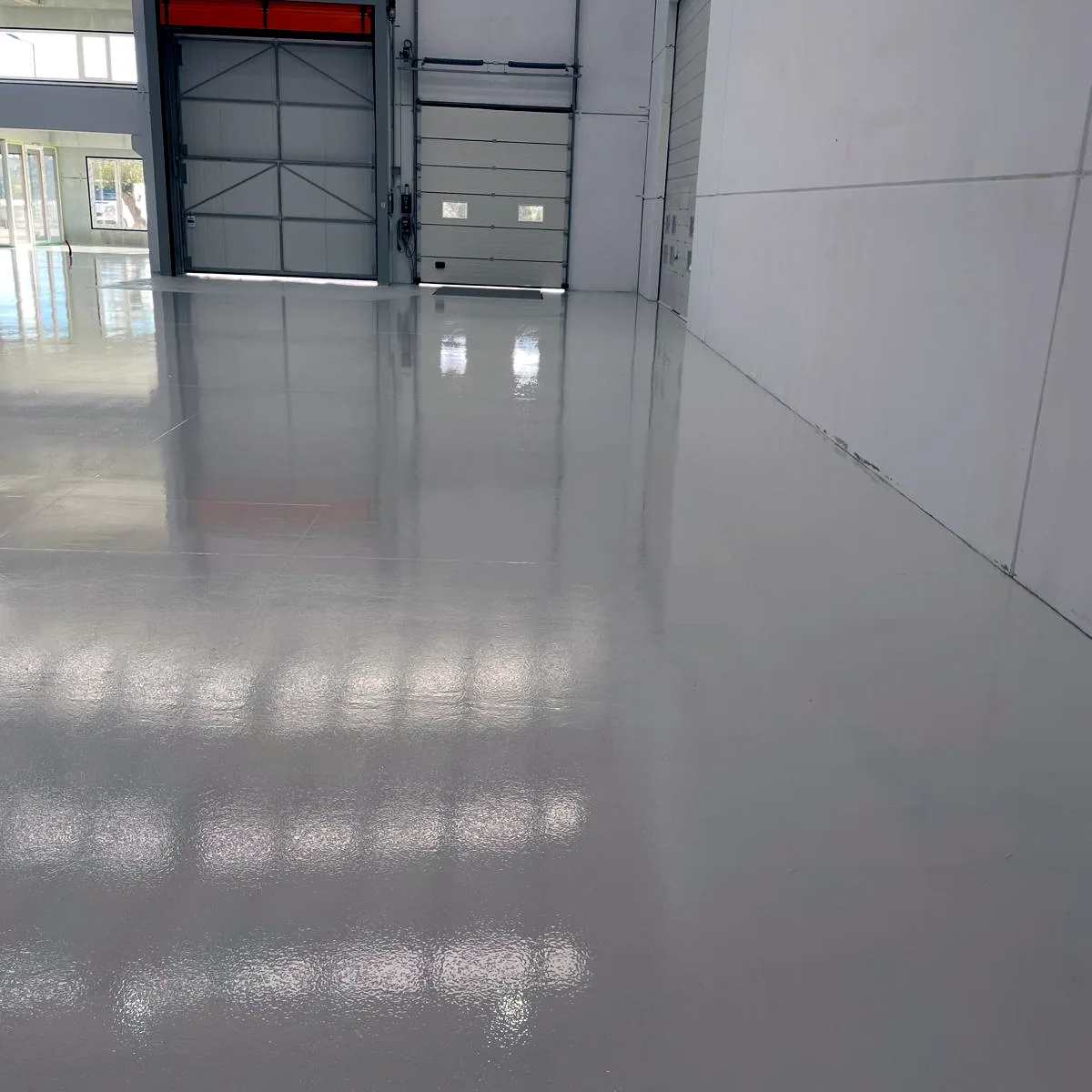 Light floor reflecting the loading doors along a side wall, Galicia